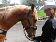 Amanda Knapp feeds grain to Carter. Knapp, 20, is the Miss Vancouver Rodeo Queen for 2014. The rodeo will be held July 2-5, at the Clark County Saddle Club.