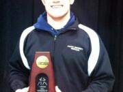 Camas wrestler Caleb Malychewski holds his fifth-place trophy from the NCAA Division III championship tournament.