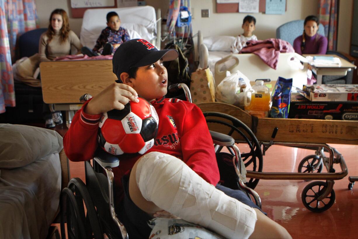 With a new soccer ball and baseball cap, Abdullah Alathamna, 11, is packed and ready to leave Shriners Hospital for Children in Los Angeles on March 19, 2010.