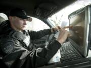 Deputy Bryce Smith checks his in-car computer during a patrol Tuesday.