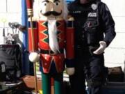 Vancouver police Cpl. Neil Martin, right, stands with a 6-foot nutcracker recovered from a storage unit.