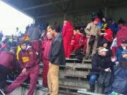 Competitors and spectators take cover at District Stadium in Battle Ground during Saturday's Tiger Invitational track and field meet.