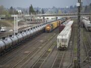 Oil tank cars move through a rail yard Wednesday in Vancouver.