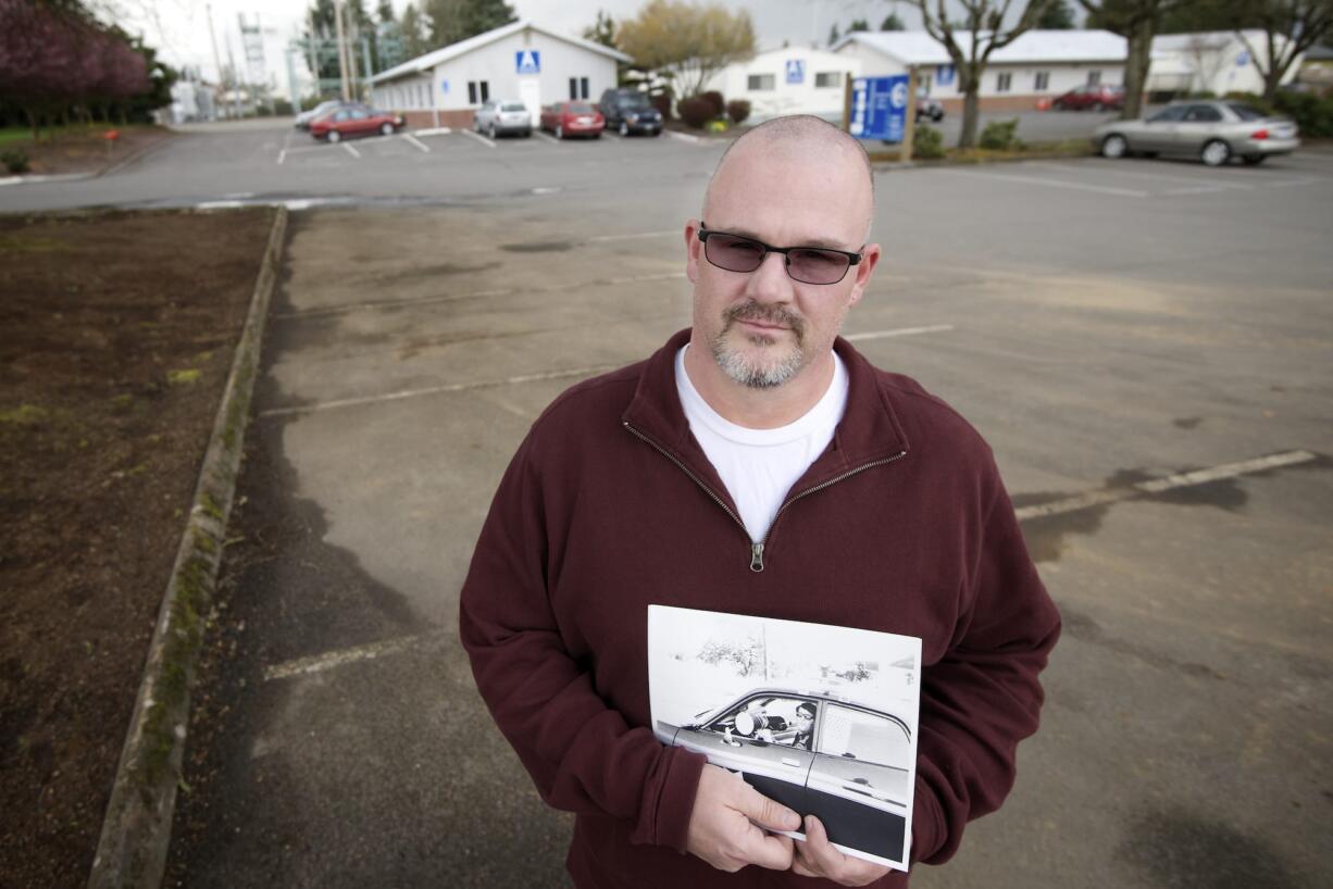 Timm Sowders holds a photograph of his father, Deputy Martin S. Sowders, in front of the Clark County Operations Center, 4700 N.E. 78th St., Vancouver.