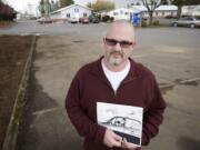 Timm Sowders holds a photograph of his father, Deputy Martin S. Sowders, in front of the Clark County Operations Center, 4700 N.E. 78th St., Vancouver.