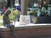 The bronze statue of a little girl will soon get its book back.