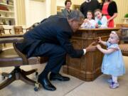 Pete Souza/Official White House photo
President Barack Obama holds the hand of Lincoln Rose Pierce Smith, the daughter of Jamie Smith, former deputy press secretary, in the Oval Office. Watching are her cousins Sage and Elsa Smith, daughters of David Smith and Bethany Rivard, a teacher Fort Vancouver High School.