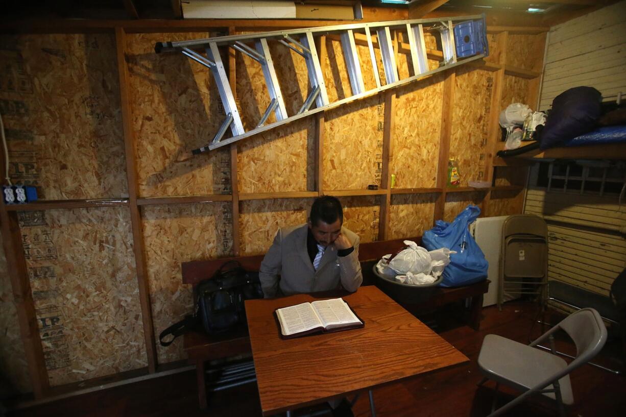 Pastor Teodoro Lorenzo of the Iglesia Evangelica Del Espiritu Santo Monte Sinai prepares for church service in early March in Oakland, Calif.