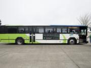 Passengers wait to board a C-Tran bus at the Vancovuer Mall Transit Center.