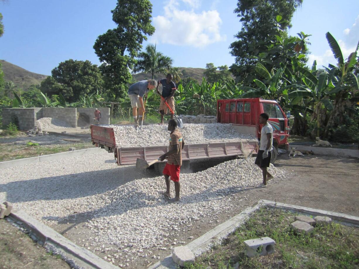 Chris Rolling, upper left, works at the Clean Water for Haiti site.