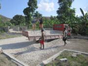 Chris Rolling, upper left, works at the Clean Water for Haiti site.