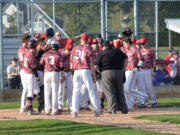 The Papermakers greet Reilly Hennessey at home plate after he hit a 3-run home run to put the finishing touches on a 14-2 victory against Skyview Monday, at Camas High School.