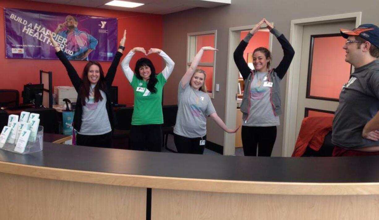 Staff members at the remodeled Clark County Family YMCA show off their new welcome center -- and their spelling skills.