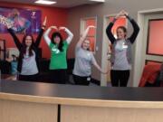 Staff members at the remodeled Clark County Family YMCA show off their new welcome center -- and their spelling skills.