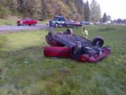 A car that was southbound on I-5 hit the barrier, rolled multiple times and ended up on its top in the grassy median near Milepost 13.