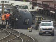 Columbian files
Crews work to right a derailed tank car containing liquid asphalt in BNSF Railway's Vancouver yard near the Fourth Plain Boulevard overpass on June 27, 2014. It was one of 33 reportable incidents in Clark County in a decade.