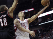 Houston's Chandler Parsons (25) drives to the basket past Portland's Nicolas Batum (88) during a game played in January in Houston.