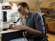 WSU Vancouver graduate student Eric Dexter examines plankton he's gathered in the Columbia River. Dexter  learned last week that he's been chosen as a participant in the 2014-15 core Fulbright U.S.