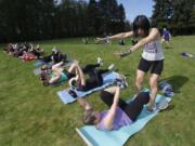 Photos by Steve Dipaola for The Columbian
May Jackson leads participants through her Be Fit Club boot camp class at Marine Park in Vancouver. Jackson hosts free boot camp classes every Saturday morning at various locations in Clark County.