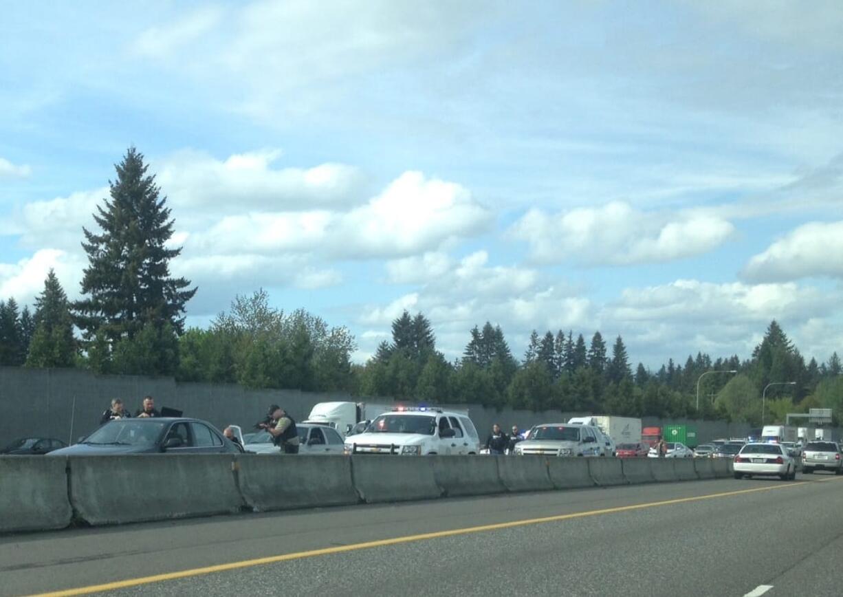 Police approach the occupants of a reportedly stolen vehicle on Interstate 5 southbound, near 99th Street.