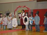 Washougal School District
Hathaway Elementary School kindergartners Rylee Quinn, as Miss U, and Wyatt Brannan, as Mr. Q, take part in a &quot;marriage&quot; of the two letters with their class. The ceremony was officiated by Principal Laura Bolt, center.