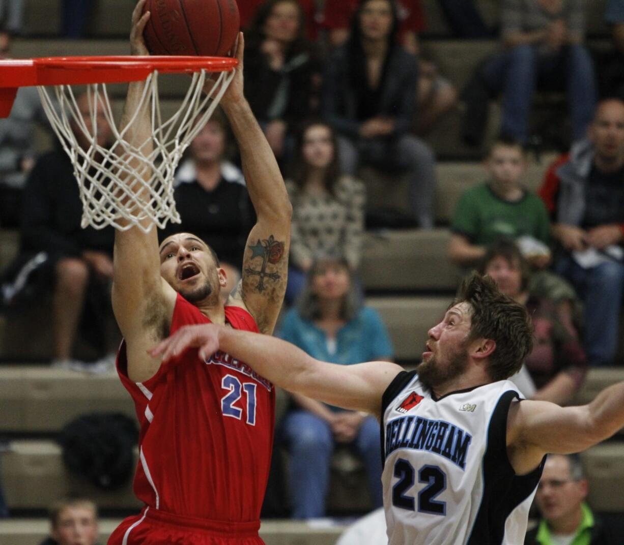 Vancouver Volcanoes guard Kevan West (L) shoots against Bellingham Slam guard Jacob Stevenson.