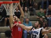 Vancouver Volcanoes guard Kevan West (L) shoots against Bellingham Slam guard Jacob Stevenson.