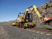 BNSF Railway workers upgrade a section of track in March on the Columbia River Gorge route more than 120 miles east of Vancouver.