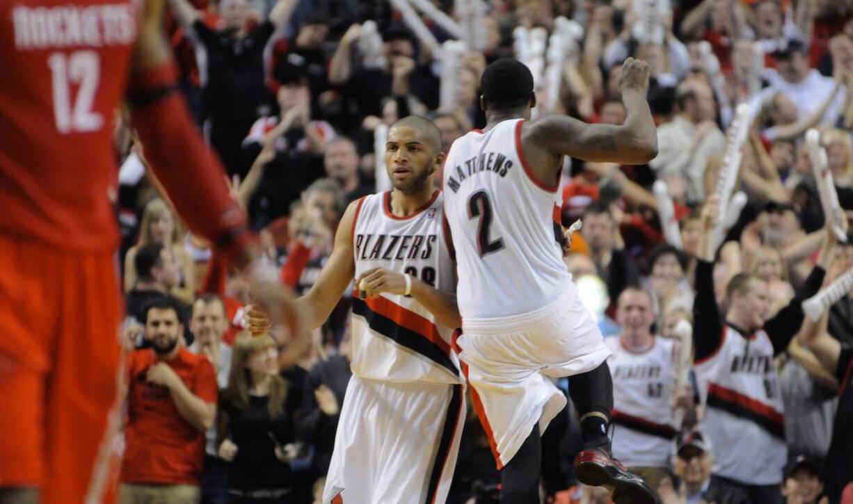 Portland Trail Blazers' Wesley Matthews (2) celebrates a 3-point shot by Nicolas Batum (88) against Houston Rockets' during the second half of game four of an NBA basketball first-round playoff series game in Portland, Ore., Sunday April 27, 2014. The Trail Blazers beat the Rockets 123-120 in overtime.