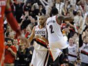 Portland Trail Blazers' Wesley Matthews (2) celebrates a 3-point shot by Nicolas Batum (88) against Houston Rockets' during the second half of game four of an NBA basketball first-round playoff series game in Portland, Ore., Sunday April 27, 2014. The Trail Blazers beat the Rockets 123-120 in overtime.