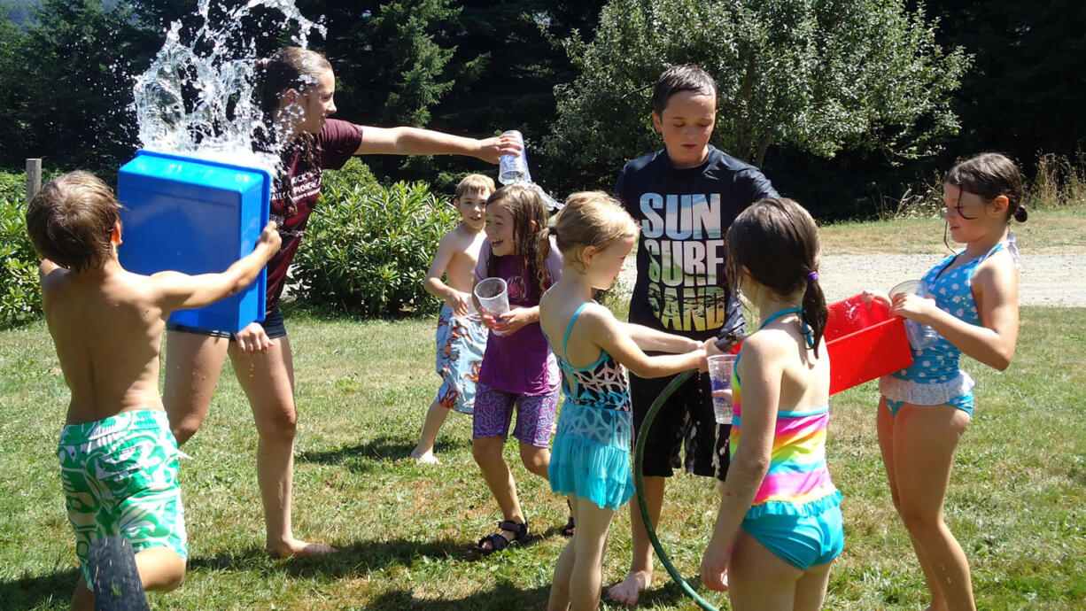 Attendees at &quot;Ooey Gooey&quot; at Camp Windy Hill  in Washougal enjoy a break to cool off during a hot summer day.