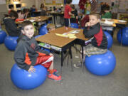 Aiden Baalaer (left) and Christian Smith enjoy using the new stability balls in their fourth-grade classroom at Cape Horn-Skye Elementary School in Washougal.