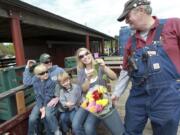 Randy Williams, president of the Chelatchie Prairie Railroad organization, hands out Mother's Day roses Sunday in Yacolt.