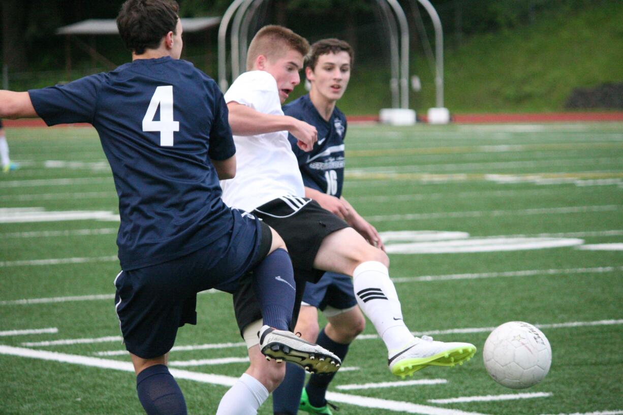 Bennett Lehner kicks the soccer ball beyond two Skyview defenders Saturday, at McKenzie Stadium. Lehner netted the tying goal for Camas in the first half.