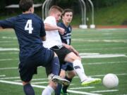 Bennett Lehner kicks the soccer ball beyond two Skyview defenders Saturday, at McKenzie Stadium. Lehner netted the tying goal for Camas in the first half.