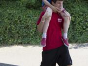 Esther Short: Trevor Saleg gives a lift to Jacob Wood at Sensory Camp, which caters to kids on the autism spectrum and with other special needs, in 2013.