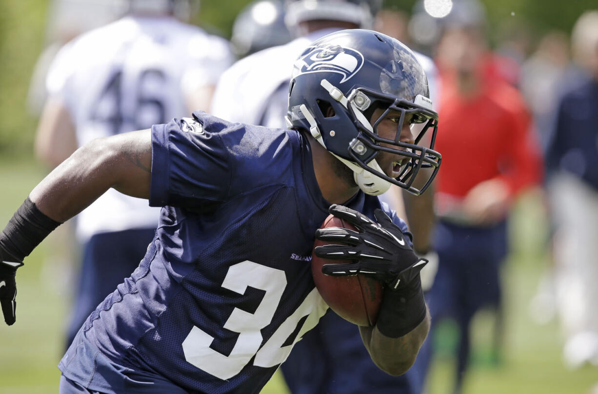 Seattle Seahawks' Kiero Small runs at an NFL football rookie minicamp Saturday, May 17, 2014, in Renton, Wash.