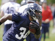 Seattle Seahawks' Kiero Small runs at an NFL football rookie minicamp Saturday, May 17, 2014, in Renton, Wash.