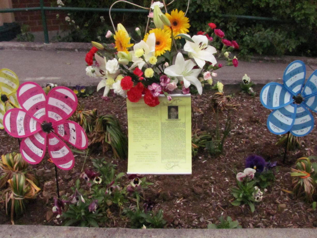 A memorial for teacher Susan Champion has been placed in the flower beds outside the entrance to Hathaway Elementary School.