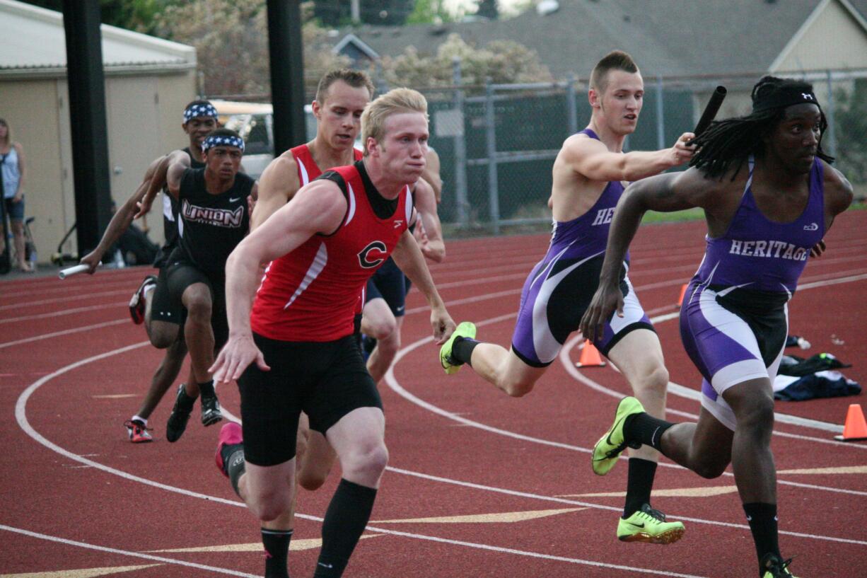 Ryan Gunther gives the baton to Cole Zarcone during the district 400-meter relay race Wednesday, at McKenzie Stadium.