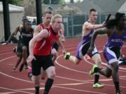 Ryan Gunther gives the baton to Cole Zarcone during the district 400-meter relay race Wednesday, at McKenzie Stadium.