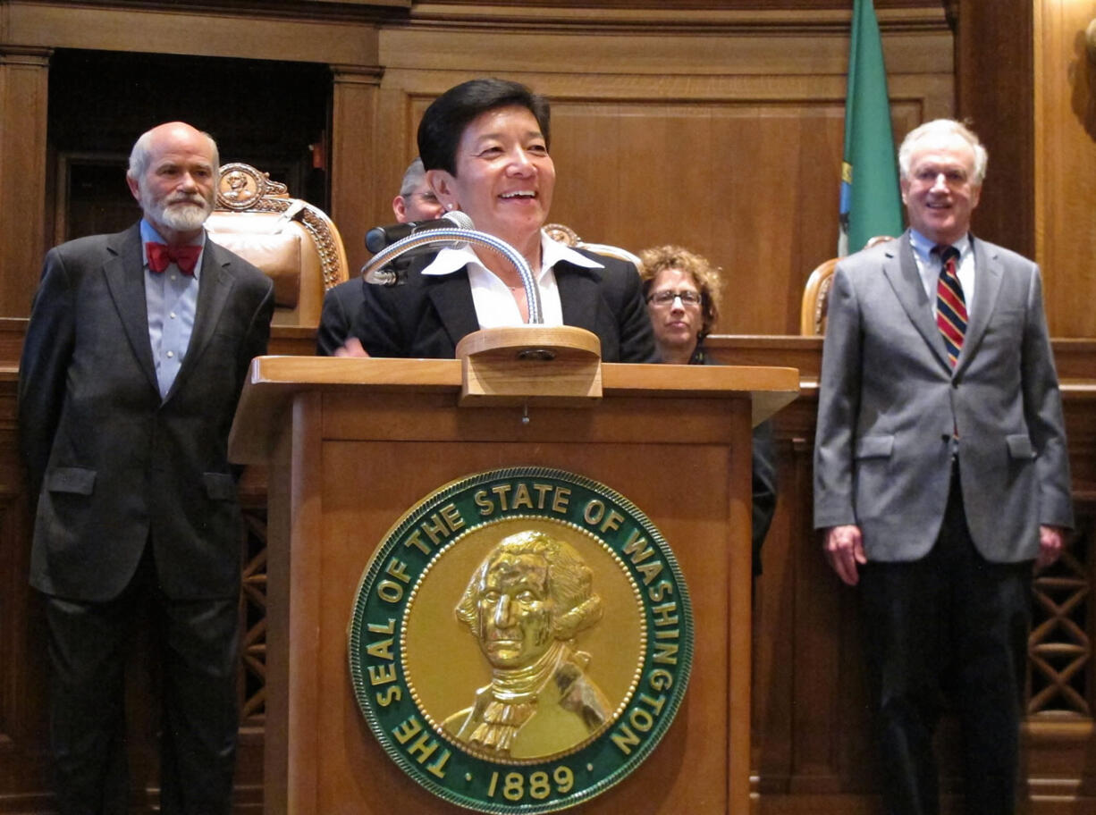 King County Superior Court Judge Mary Yu, standing in front of members of the Washington state Supreme Court, responds to the announcement of her appointment to the high court on  May 1 in Olympia.