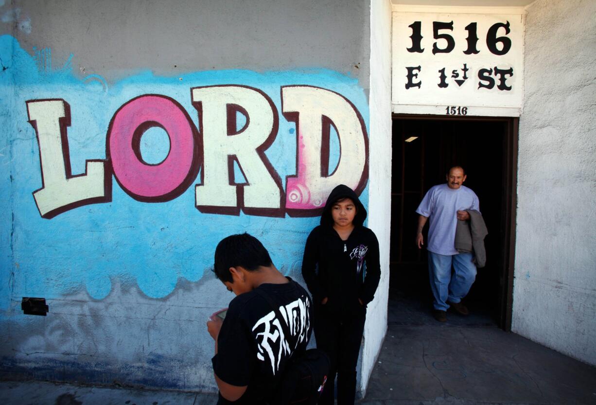 Eliasar Avalos, left, and his sister Angelina wait for their parents March 30 after Pastor Joey Oquendo's service at the Boyle Heights Christian Center in Los Angeles on March 30.