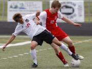 Camas defender Sam Pizot, left, battles with Ferris forward Eric Hollenbaugh in 4A state quarterfinal game Saturday at Doc Harris Stadium. Hollenbaugh scored Ferris' first half goal and the winning penalty kick following overtime to eliminate the Papermakers from the state tournament.