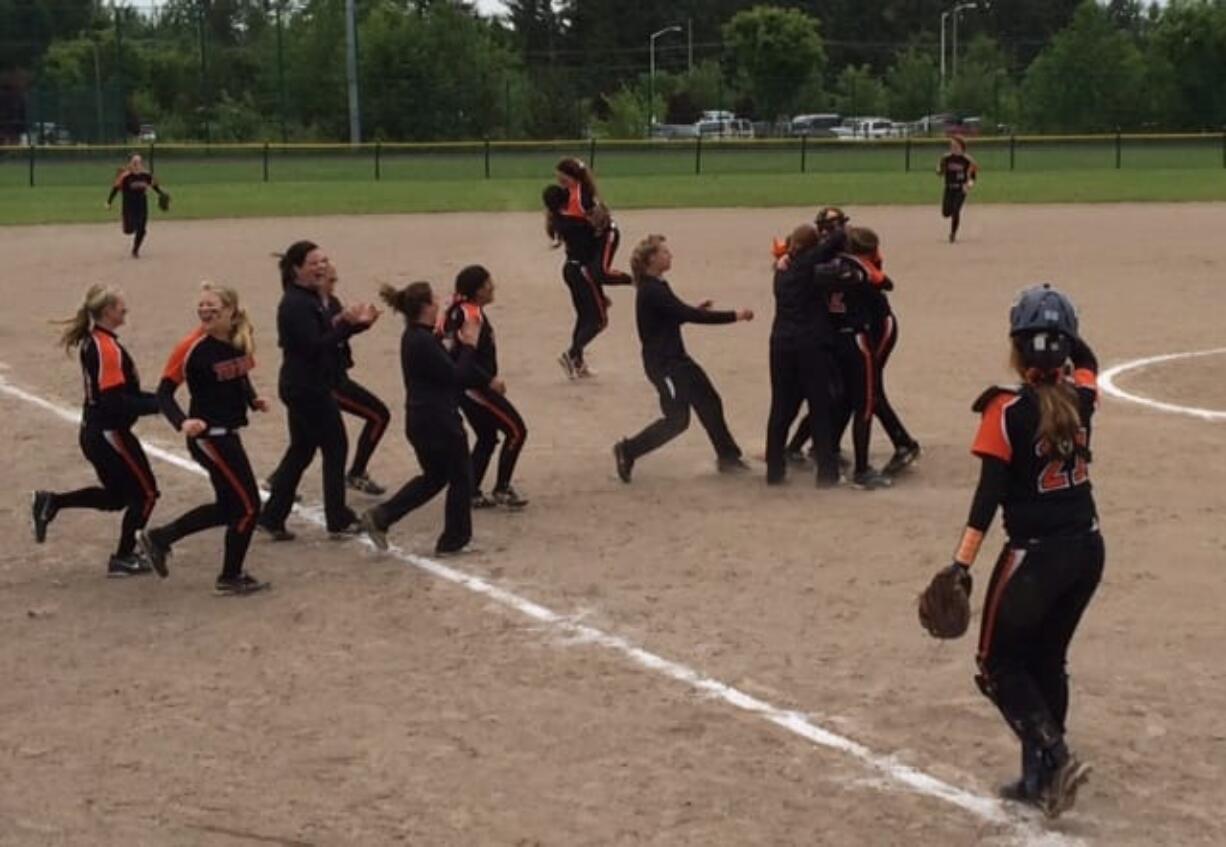 Battle Ground players celebrate their 6-3 victory over Emerald Ridge on Sunday at Kent, which put the Tigers in the Class 4A state softball tournament for the first time.