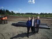 Kris Vockler, center, chief executive officer of Vancouver-based ICD High Performance Coatings, and her parents, Patricia and Larry Vockler, company founders, visit the Ridgefield construction site where the firm's larger production facility will be built.