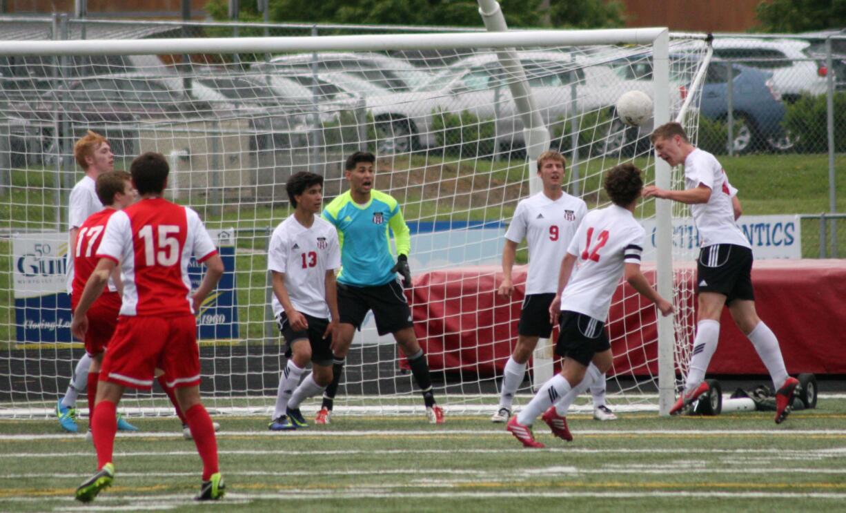 Matt Palodichuk defends a shot taken by Ferris in the state quarterfinal game Saturday, at Doc Harris Stadium.