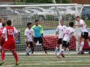 Matt Palodichuk defends a shot taken by Ferris in the state quarterfinal game Saturday, at Doc Harris Stadium.