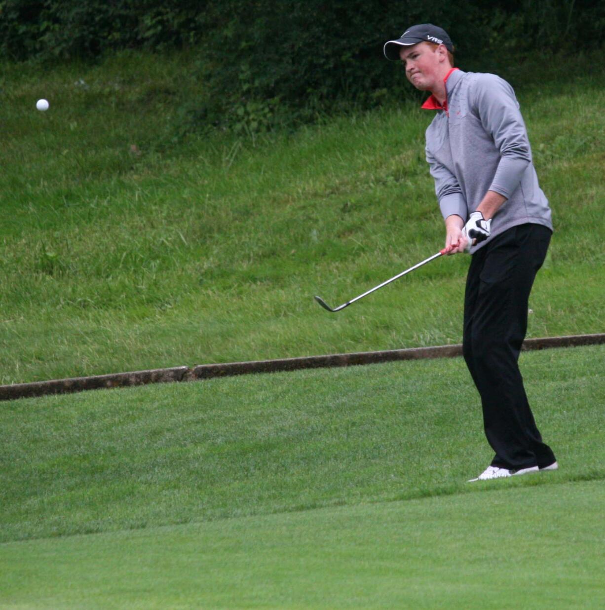 Brian Humphreys chips on to the ninth green during the final round of the 4A state boys golf tournament at Camas Meadows.