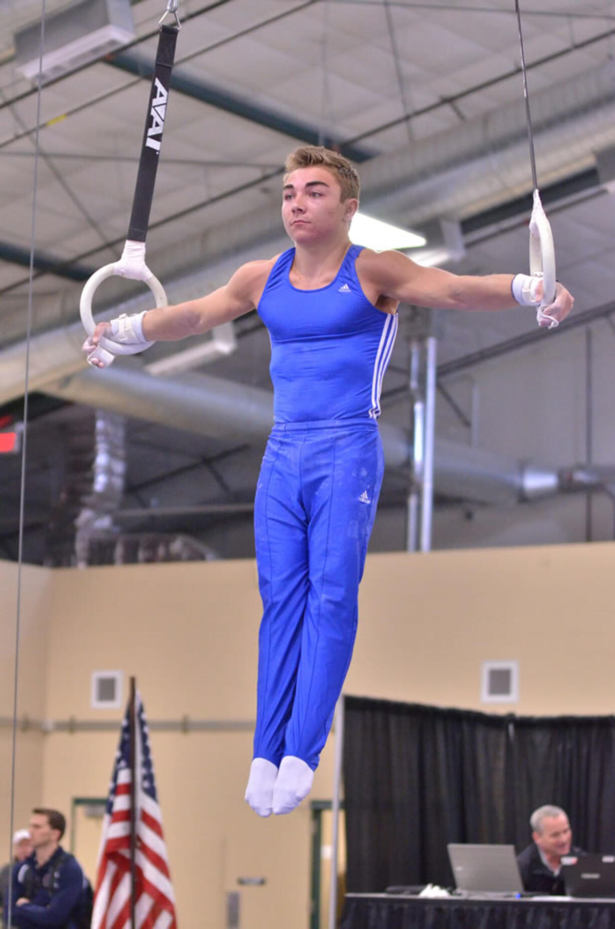 Nick McAfee performs the iron cross on the rings.